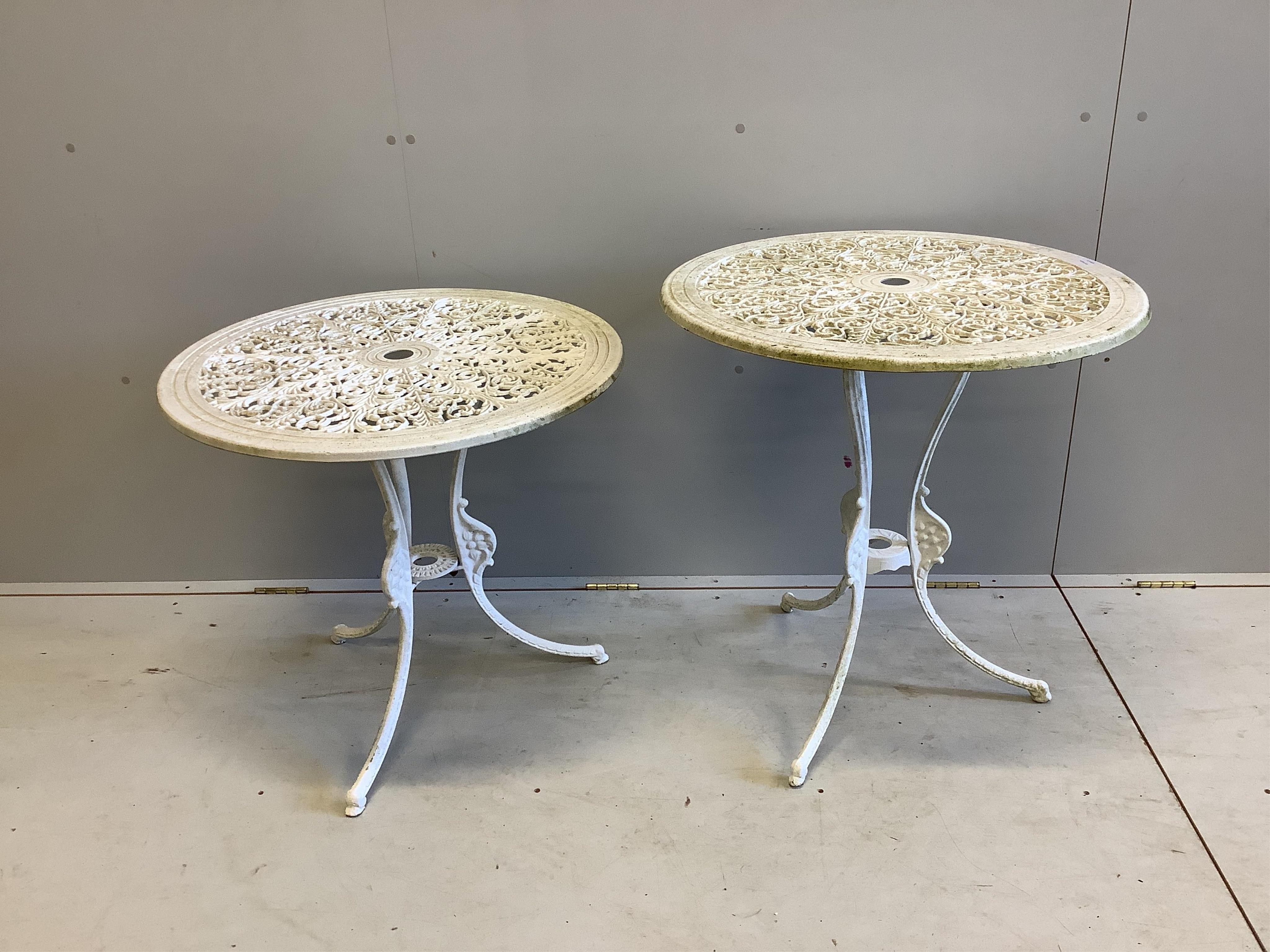 A Victorian style white painted cast aluminium three piece garden suite, bench width 126cm, depth 50cm, height 78cm and a two similar circular topped garden tables. Condition - fair